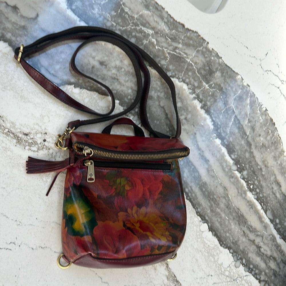 Patricia Nash floral leather bag. Never used. 11”tall, 8” wide, adjustable strap